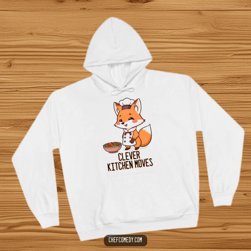 Funny Fox Chef Hoodie: A cozy hoodie featuring a triumphant fox chef presenting a steaming dish, perfect for culinary glory.