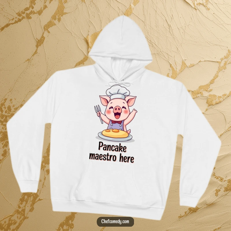 Funny hoodie featuring a cute pig chef in action, joyfully flipping a pancake, embodying culinary happiness.