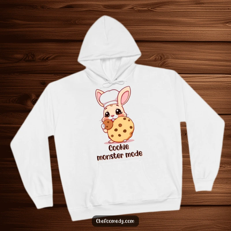 Funny Rabbit Chef Hoodie: A soft hoodie featuring a rabbit chef with wide eyes joyfully tasting a giant cookie.