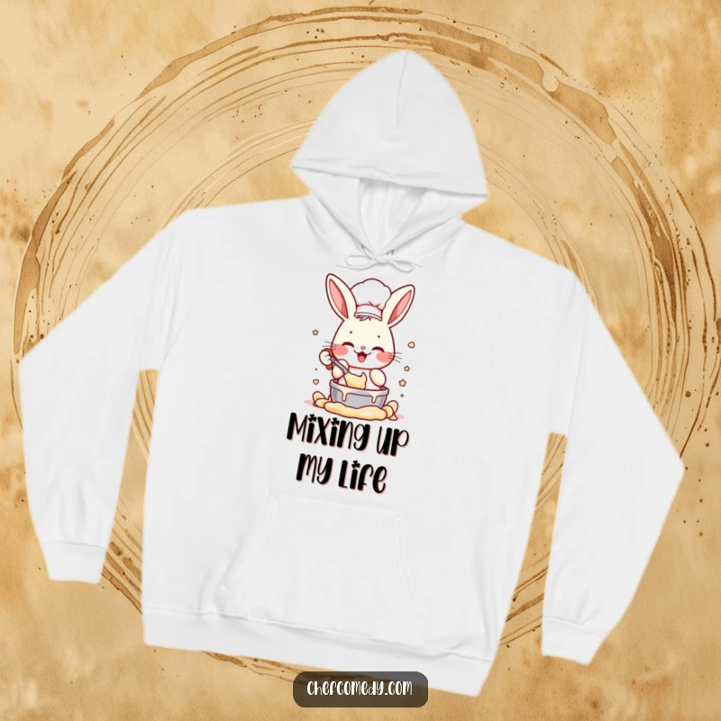 Funny hoodie with an energetic rabbit chef character enthusiastically mixing batter, perfect for cozy baking sessions and a humorous gift.