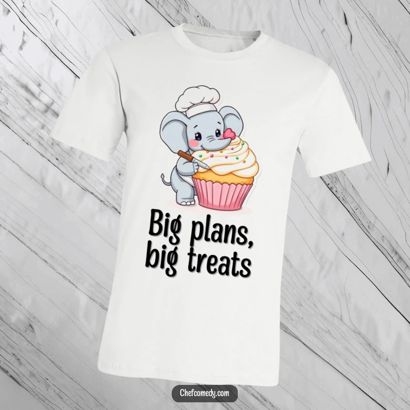 Funny t-shirt featuring a gentle elephant chef meticulously decorating an enormous cupcake with intricate frosting details, perfect for sweet occasions.