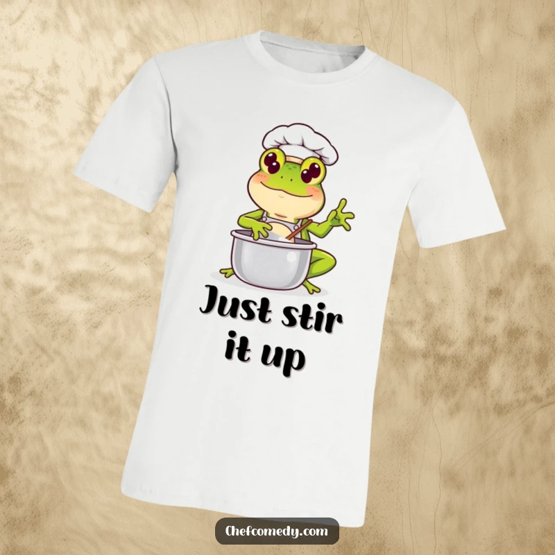 Funny Kawaii Frog Chef T-Shirt: A cheerful green frog chef with a big smile energetically stirs a pot, ready to whip up a tasty meal.