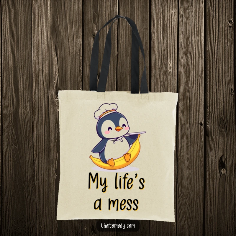 Funny Penguin Chef Tote Bag: Features a penguin chef comically sliding on a banana peel with a plate, a humorous carry-all.
